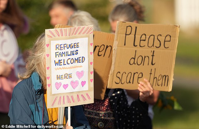 More signs from counter protesters read: 'Refugee families welcomed here', and 'please don't scare them'