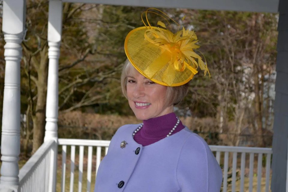 Suzanne Eberson Adams wearing a yellow hat.