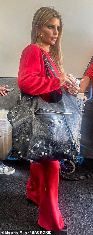 Jessica was dressed for comfort on the flight as she sported a bright red sweat suit