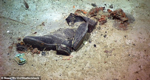 The shoes of a Titanic victim are photographed in a debris field near the stern of the ship