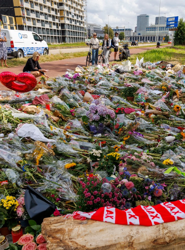 Floral tributes at a murder victim's memorial.