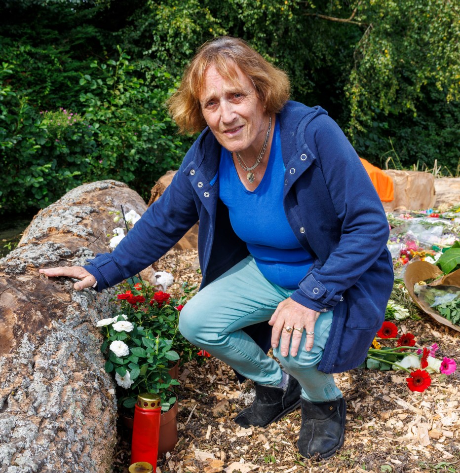 Woman laying flowers at a memorial.