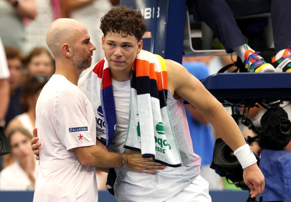 Adrian Mannarino of France and Ben Shelton of the United States embrace after a tennis match.