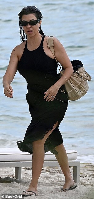 She tucked her locks behind her ear after swimming in the ocean