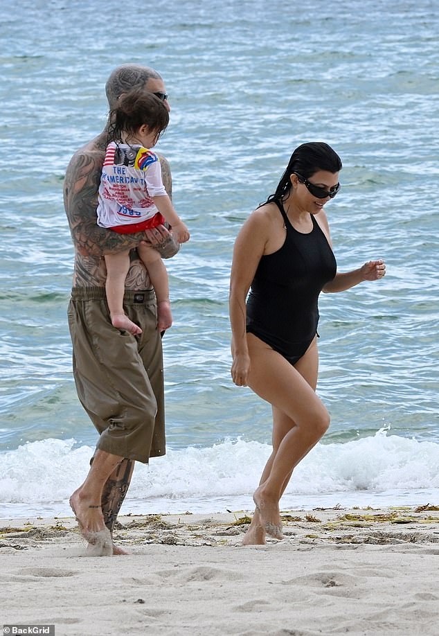 Travis kept his look simple as he sported a pair of long, brown baggy board shorts and black sunglasses