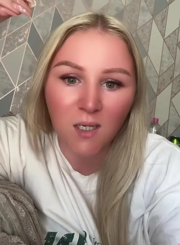 Woman with blonde hair speaking to camera, text overlay: "It's not normal to be skint! What kind of life is this!"