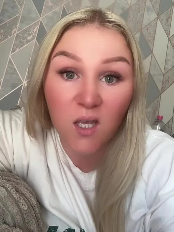 Woman speaking directly to the camera, stating, "It's not normal to be skint! What kind of life is this!"