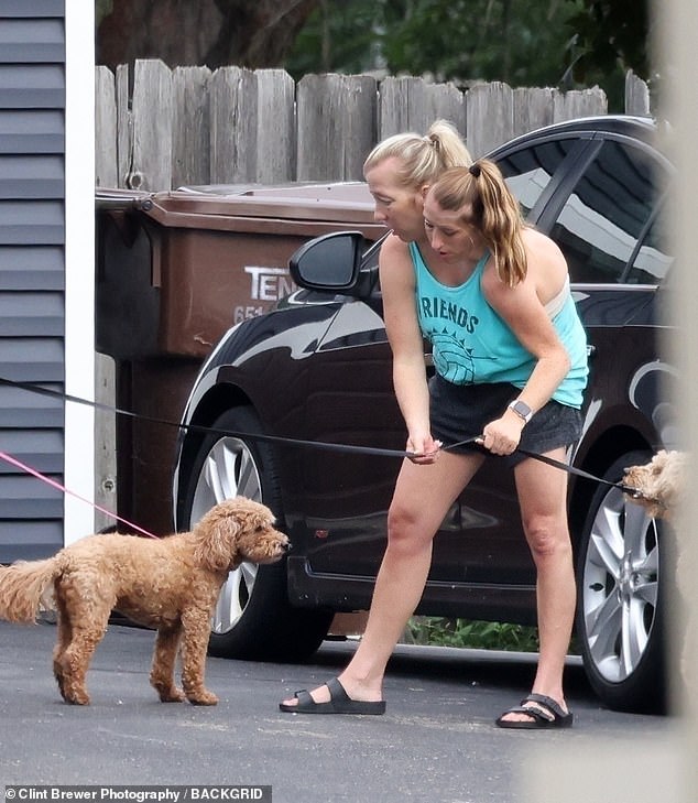 Dressed in a light blue tank top and sandals, the 'ultra-rare' twins were seen walking with their curly-haired dog
