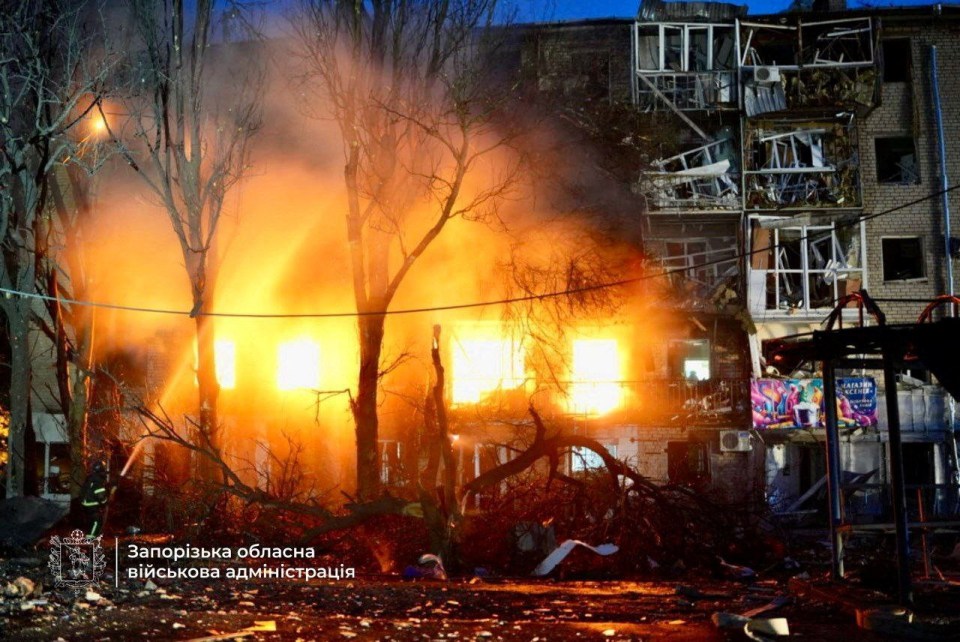Firefighters at the site of a burning apartment building in Zaporizhzhia, Ukraine, after a Russian drone and missile strike.