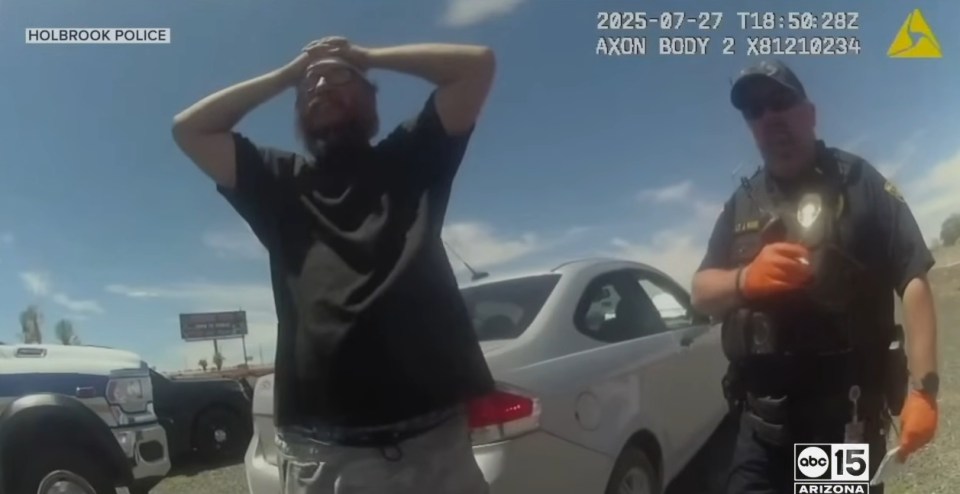 Man being questioned by police officer.