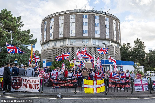 More than 200 protesters against asylum seekers being housed in hotels gather outside The Roundhouse in Bournemouth on Friday night