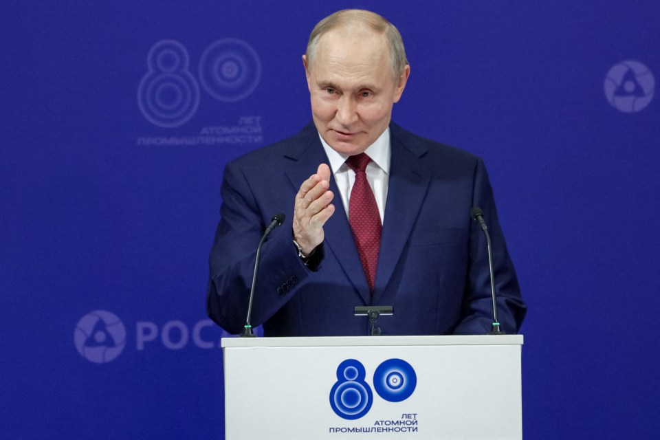 Vladimir Putin speaking at a podium.