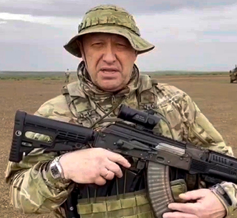 Yevgeny Prigozhin holding an assault rifle.