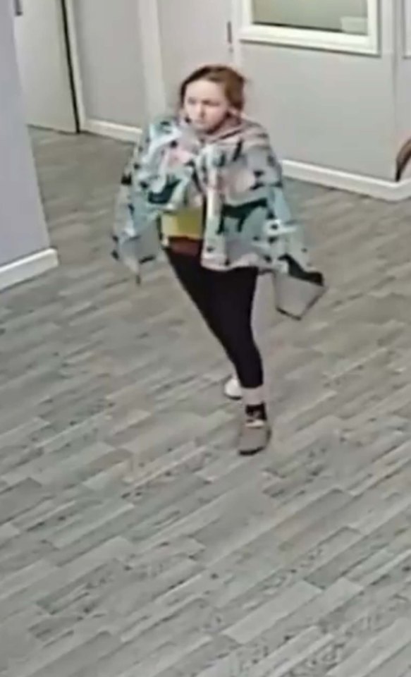 CCTV footage of a teenage girl walking in a hospital hallway.