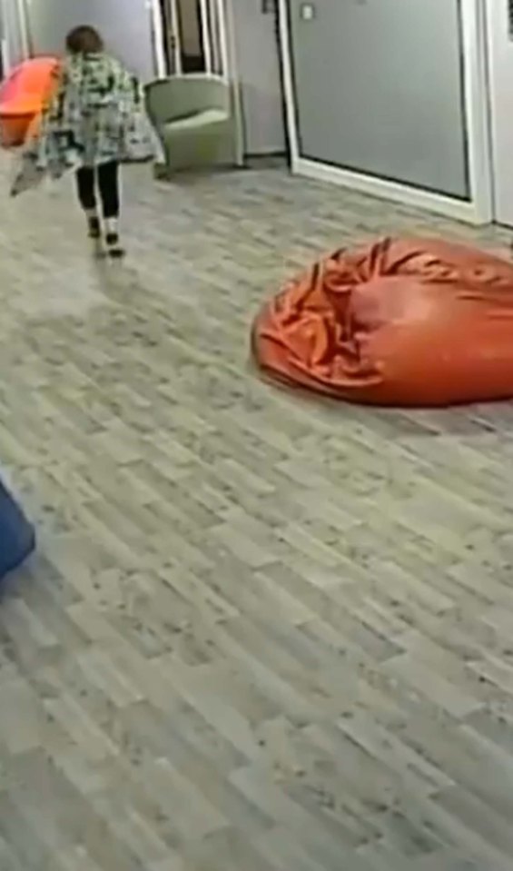 CCTV footage of a girl walking down a hospital corridor.