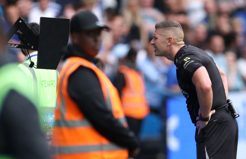 Referee Robert Jones reviewing a VAR decision.
