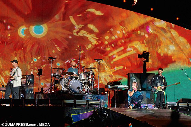 Chris Martin, Guy Berryman, Jonny Buckland, and Will Champion perform live on stage at Wembley Stadium