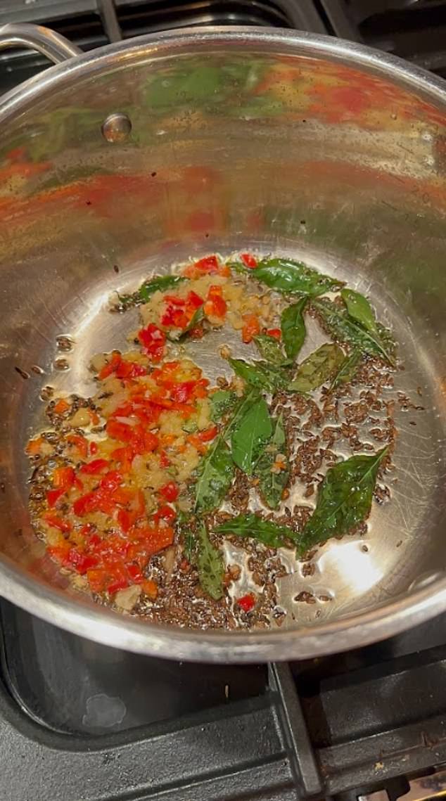 The spices are cooked with sweet potato, cauliflower and cashews and water