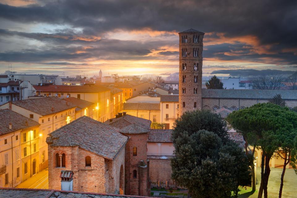 Ravenna, Italy skyline at sunset, featuring the Basilica of Sant'Apollinare Nuovo bell tower.