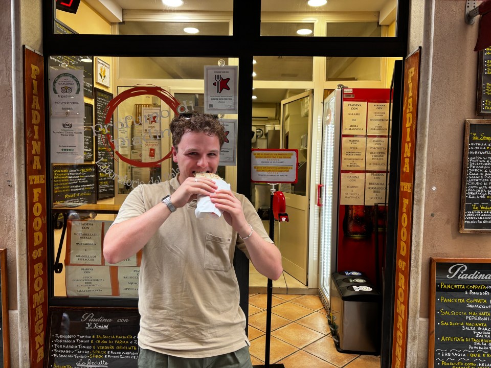 Man eating piadina in Ravenna, Italy.