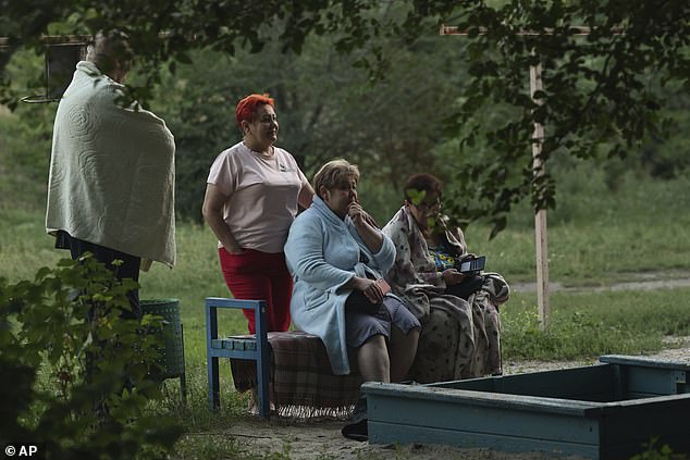 Local residents look at their destroyed home following Russian air strike in Zaporizhzhia, Ukraine, Saturday, Aug. 30, 2025