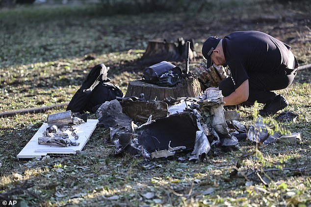 A police officer inspects fragments of the Russian rocket after Russian missile attack in Zaporizhzhia, Ukraine, Saturday, Aug. 30, 2025