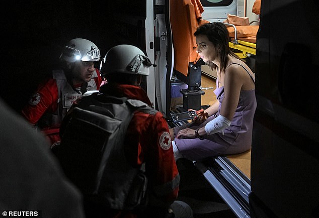 Medical workers treat a resident at the site of an apartment building hit during Russian drone and missile strikes, amid Russia's attack on Ukraine, in Zaporizhzhia, Ukraine August 30, 2025