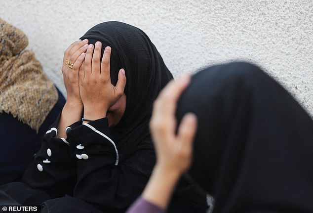 Mourners react during the funeral of Palestinians who were killed by Israeli fire while trying to receive aid and another killed in a strike on Friday, according to medics, at Al-Shifa Hospital in Gaza City, August 30, 2025