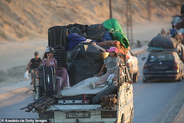 Palestinians flee their homes as intense Israeli attacks on northern Gaza force them to head toward central Gaza via al-Rashid Road, carrying whatever belongings they can, on August 29, 2025 in Gaza