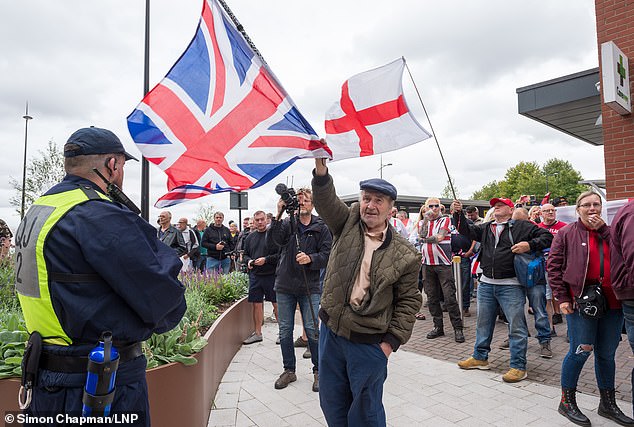 Photos show campaigners holding Union Jacks and England flags gathering outside hotels in Newcastle, Swindon (pictured), Falkirk and Stoke-on-Trent this afternoon