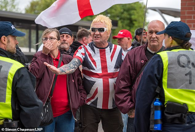 Anti-migrant protesters (pictured) hold a demonstration outside the Thistle Hotel in Swindon