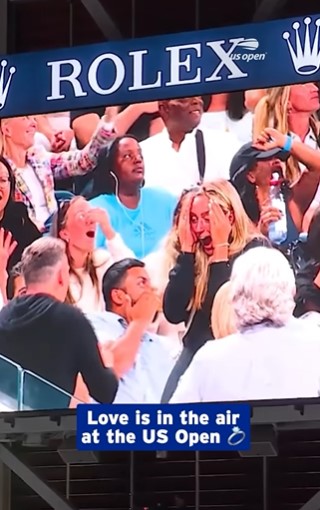 Screenshot of a jumbotron showing a marriage proposal at the US Open.