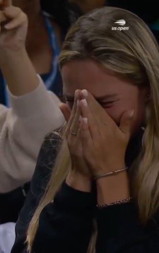 Woman crying and covering her face with her hands.