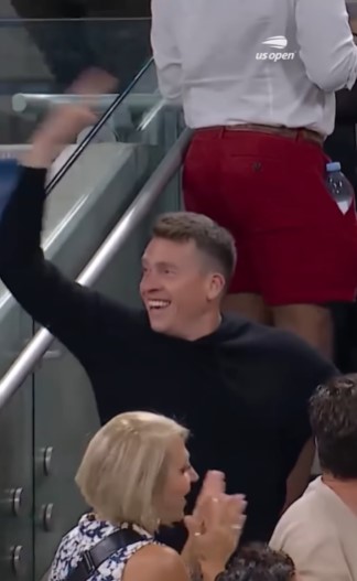 Man celebrating at a US Open tennis match.