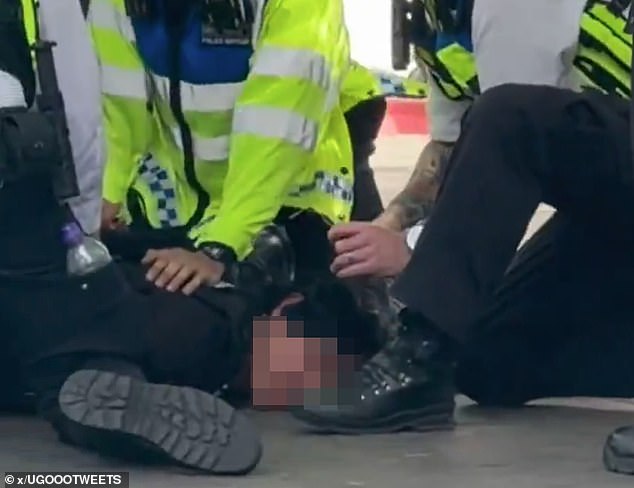 Other officers searched the suspect's bag and maintained a cordon around the area as astonished Chelsea fans passed by