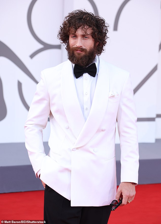 Slipping his feet into shiny dress shoes the actor also wore a huge wristwatch, after signing a deal with official 007 watch provider Omega