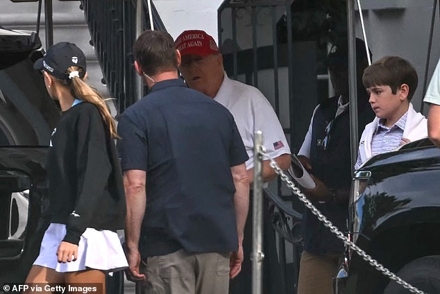 The outing came amid wild rumors surrounding the Repulican's health. Trump sported his go-to golf outfit - black pants, a white polo shirt and his signature red MAGA hat