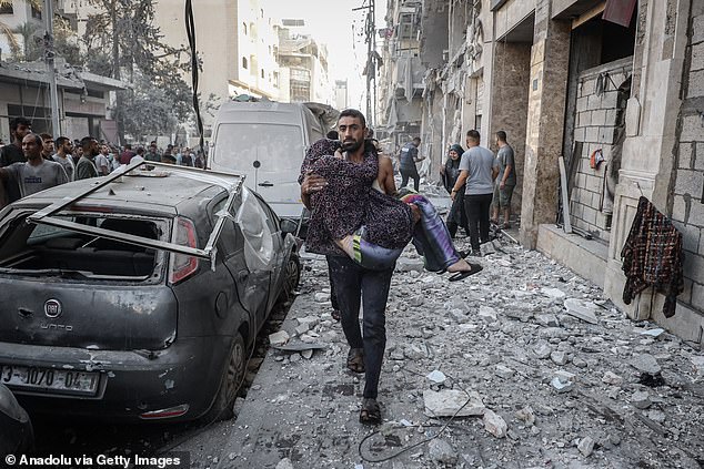 Injured Palestinians, including children, are transported to hospital by ambulance after an Israeli attack on the Rimal neighborhood in northern Gaza