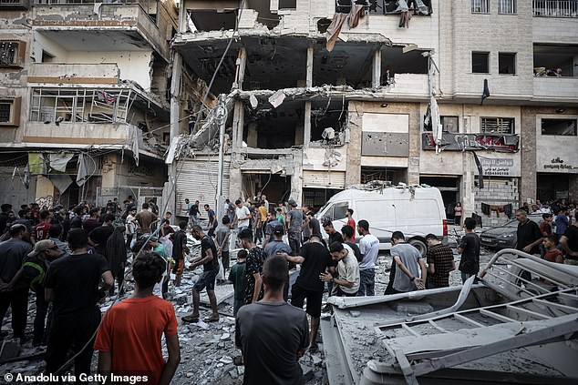 A building destroyed by strikes from Israel in Rimal as residents search for casualties