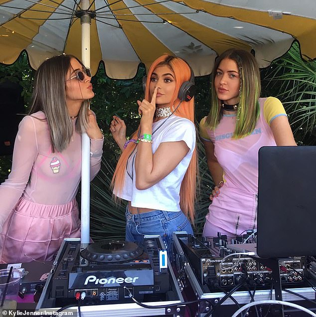 Nearly ten years ago the TV star-turned-entrepreneur teamed her vibrant peach-toned wig with dramatically thick eyebrows, smokey eye makeup, and plump lips; pictured with Simi and Haze in April 2016