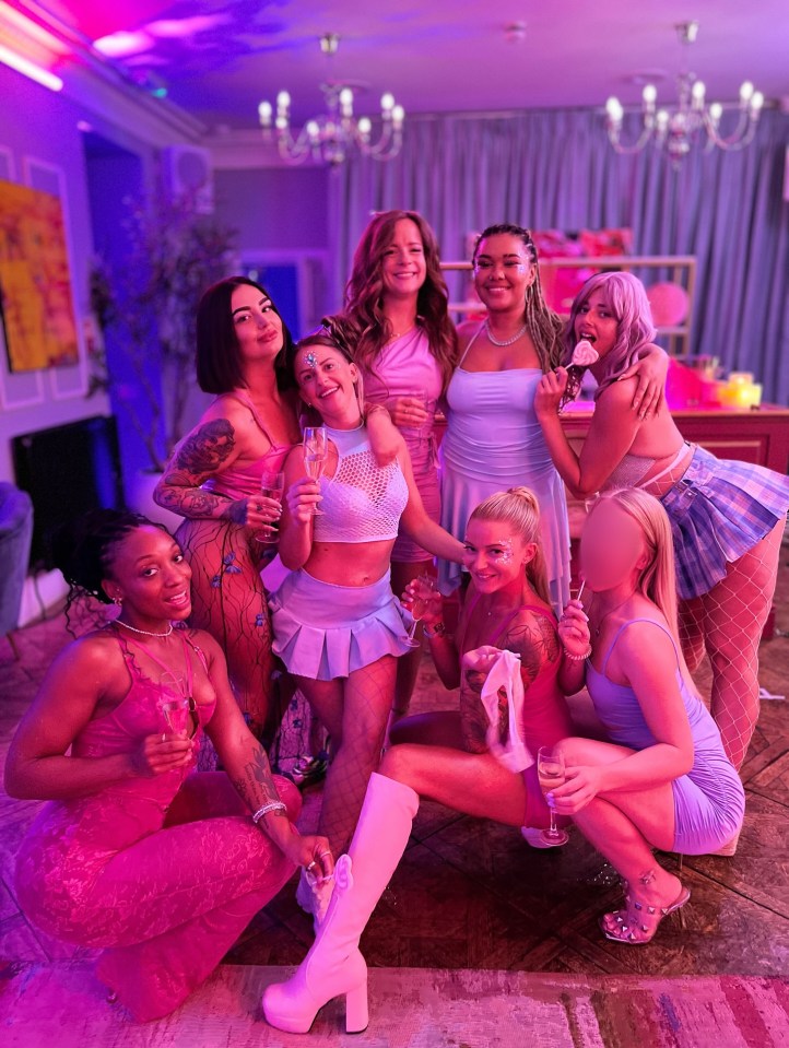 Group of women in pink and purple outfits at a party.