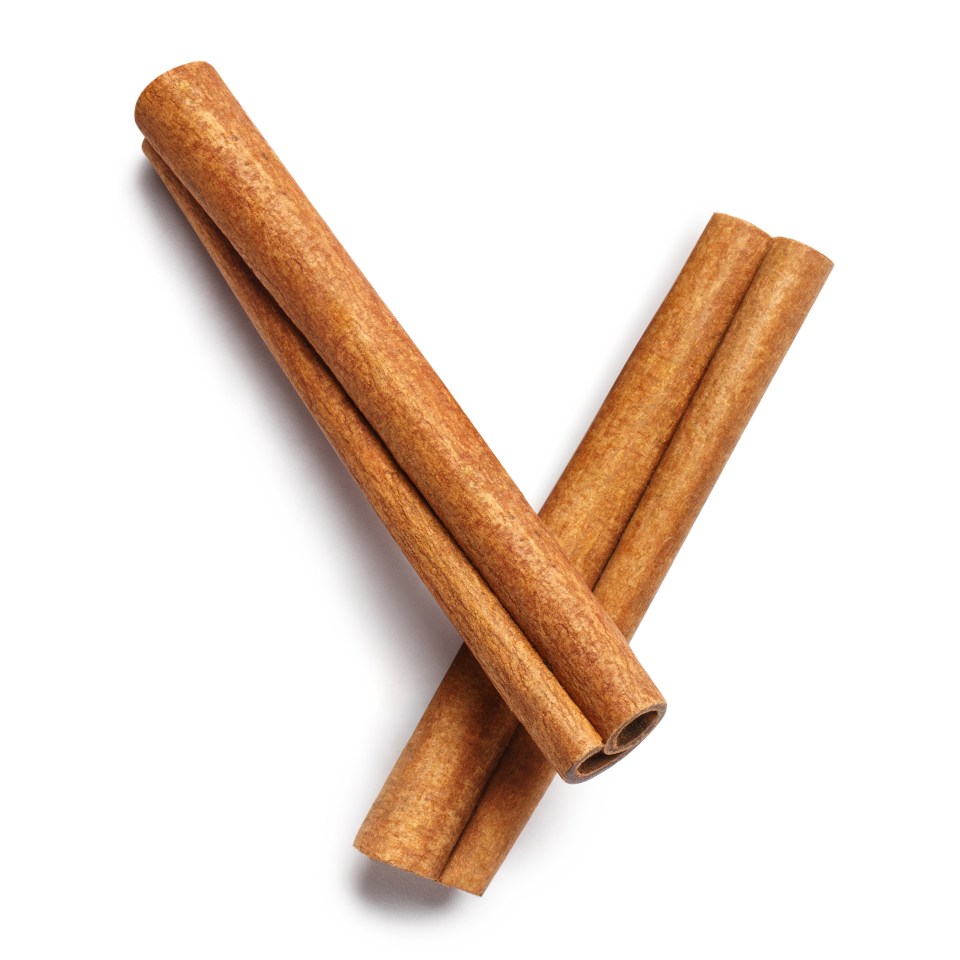 Two delicious cinnamon sticks, view from above, isolated on white background