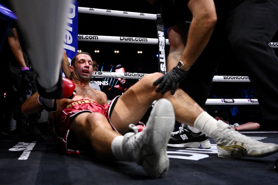 Luke Rockhold on the canvas after being knocked down during a boxing match.
