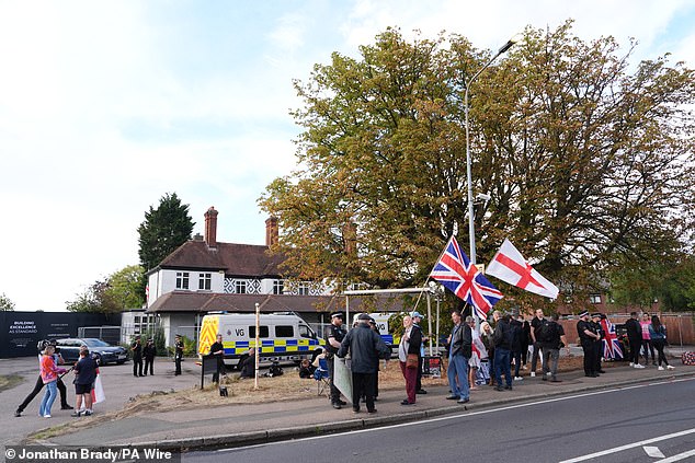 Police and protesters outside the Bell Hotel in Epping, Essex, following the court ruling