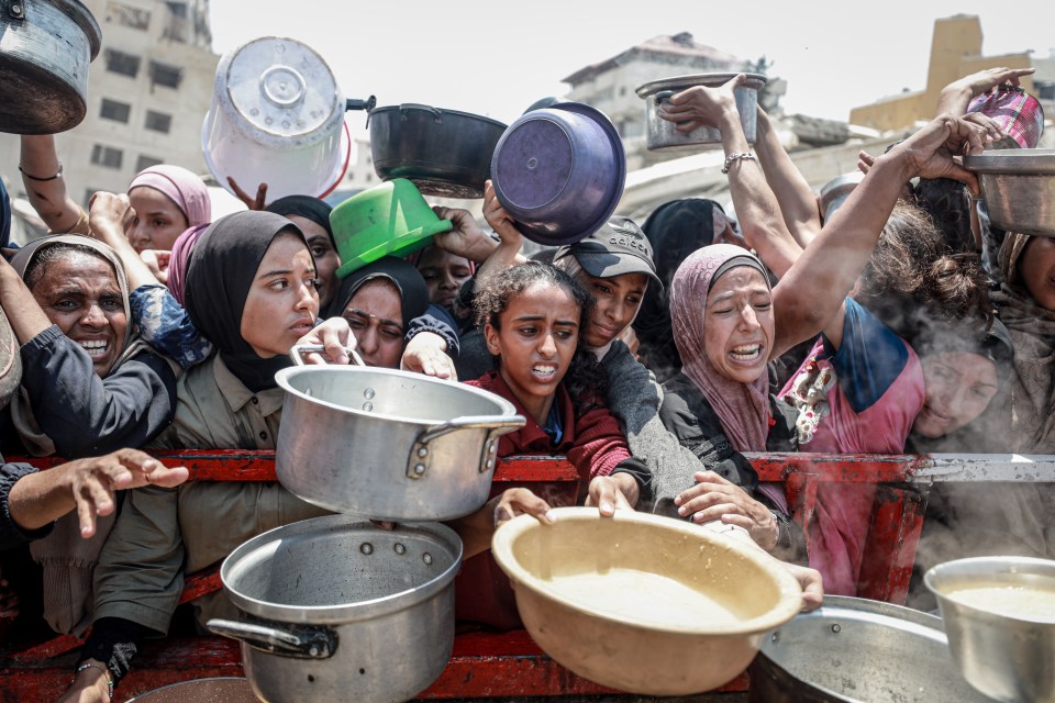 Palestinians receive hot meals in Gaza.