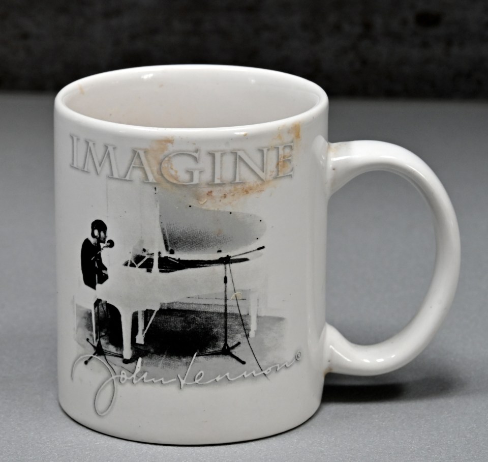 Mug with lip marks and a John Lennon image.