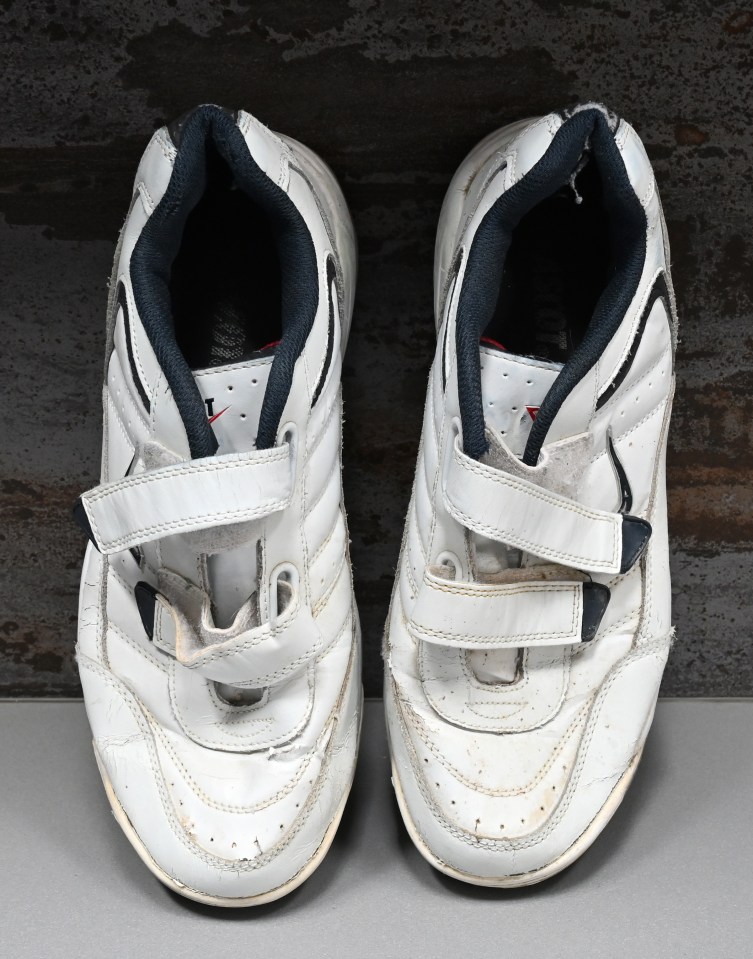 Pair of worn white sneakers.