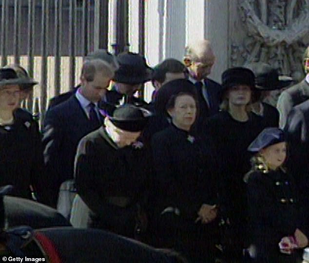 While standing with her family, the Queen bowed her head as the cortege passed