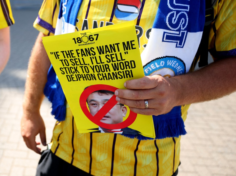 Sheffield Wednesday fan holding a leaflet protesting owner Dejphon Chansiri.
