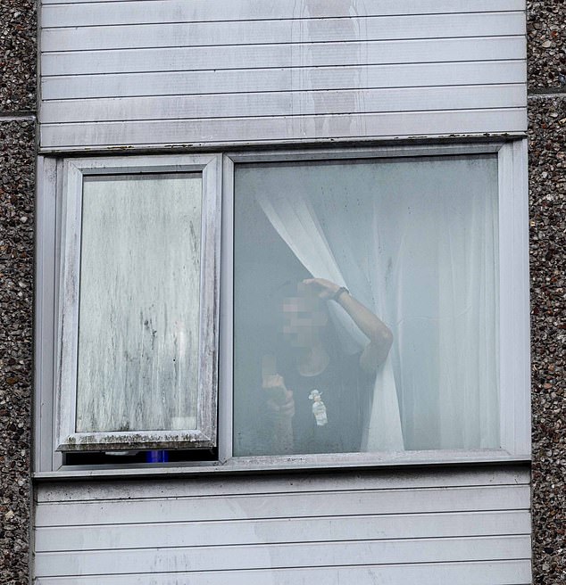The young man was seen at the window of the Roundhouse hotel in Bournemouth, Dorset, last night, as 200 demonstrators gathered outside